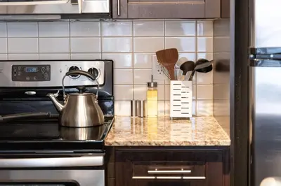 a kitchen with a stove with a tea kettle on it at DWTN Condo Near CN Tower! w/ Free Parking in Toronto