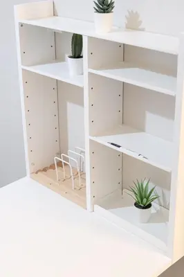 a white shelving unit with plants on it at DWTN Condo Near CN Tower! w/ Free Parking in Toronto