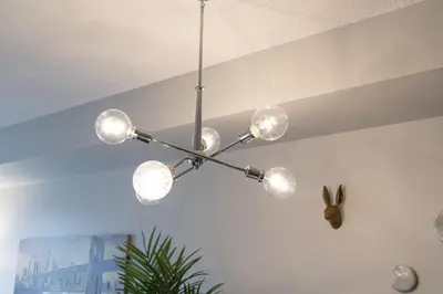 a chandelier hanging from a ceiling in a room at DWTN Condo Near CN Tower! w/ Free Parking in Toronto