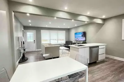 a kitchen and living room with a table and chairs at White House Suite - Sleeps 4 in St. Catharines