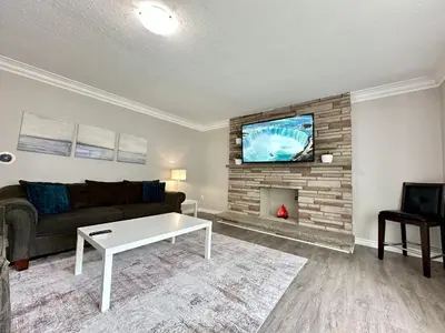 a living room with a couch and a fireplace at Mountain View Suite - Sleeps 6 in St. Catharines