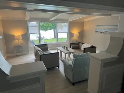 a living room with couches and a table at The Captains Lake House in Orillia