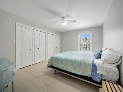 a bedroom with a bed and a ceiling fan at The Captains Lake House in Orillia
