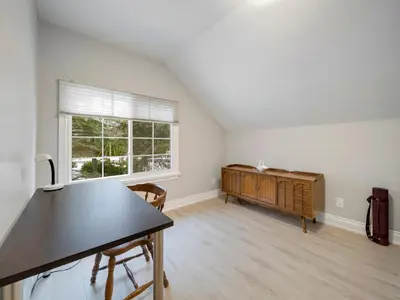 an empty living room with a table and a window at The Captains Lake House in Orillia