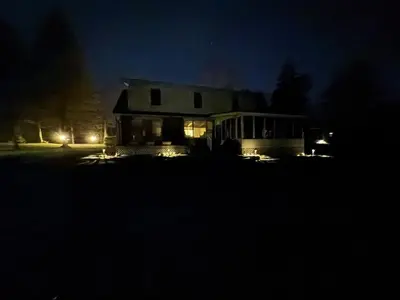 a house at night with lights in the dark at The Captains Lake House in Orillia