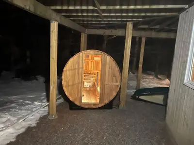 a small wooden room in a building with snow at Lovely Muskoka Waterfront Cottage-Hot tub & Sauna! in Bracebridge