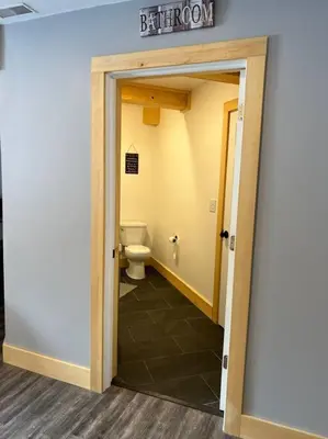 an open door to a bathroom with a toilet at Lovely Muskoka Waterfront Cottage-Hot tub & Sauna! in Bracebridge