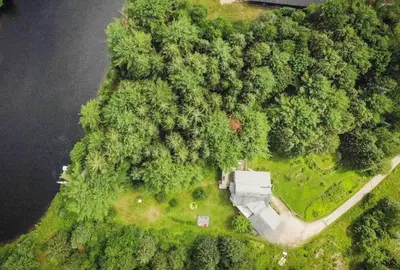 an aerial view of a house in the middle of a forest at Lovely Muskoka Waterfront Cottage-Hot tub & Sauna! in Bracebridge