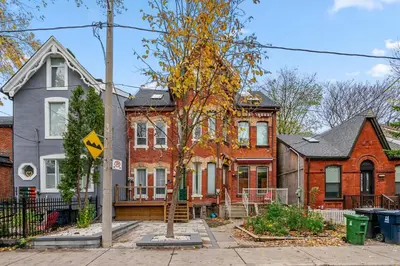a group of houses on a city street at Historic Victorian with Deck and Parking in Toronto