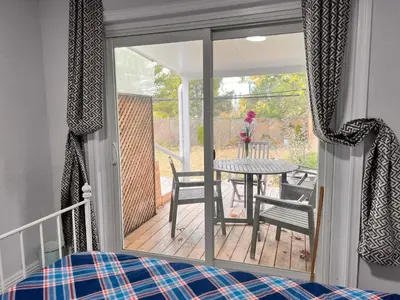 a bedroom with a view of a deck with a table at 3 BR GREAT HOUSE WITH ONE parking in Richmond Hill