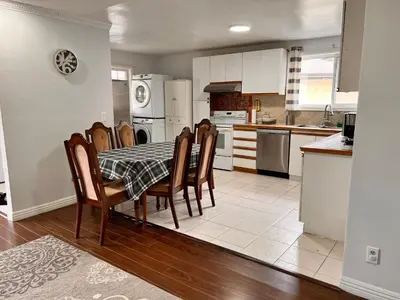 a kitchen with a table and chairs in it at 3 BR GREAT HOUSE WITH ONE parking in Richmond Hill
