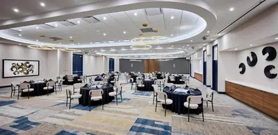 a banquet hall with tables and chairs in a room at Candlewood Suites Burlington Conference Centre by IHG in Burlington
