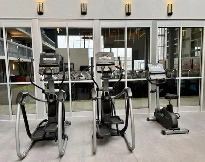 a room with three exercise bikes in front of a building at Candlewood Suites Burlington Conference Centre by IHG in Burlington