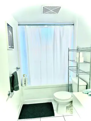 a bathroom with a white toilet and a shower at Lush Condo By CNTower - Free Parking in Toronto
