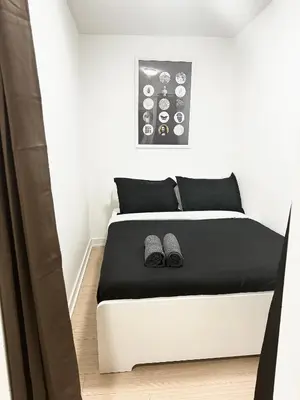 a bedroom with a bed with two slippers on it at Lush Condo By CNTower - Free Parking in Toronto
