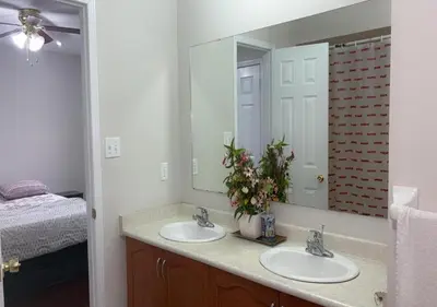 a bathroom with two sinks and a large mirror at Beautiful private Room near Toronto pearson Airport in Brampton