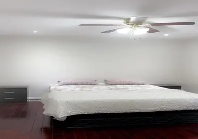 a bedroom with a bed with a ceiling fan at Beautiful private Room near Toronto pearson Airport in Brampton