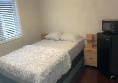 a bedroom with a bed and a tv on a dresser at Beautiful private Room near Toronto pearson Airport in Brampton