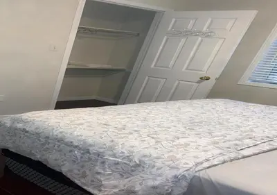 a bedroom with a bed and a white door at Beautiful private Room near Toronto pearson Airport in Brampton