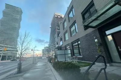 a building on a city street with tall buildings at Modern Luxury 3 bed rooms House in Toronto Mississauga in Mississauga
