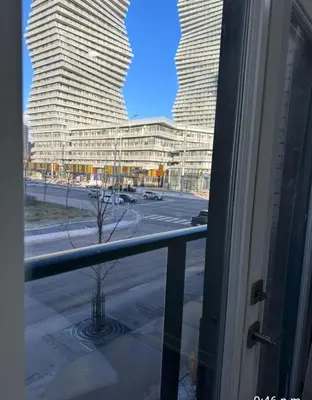 a window with a view of a street and two tall buildings at Modern Luxury 3 bed rooms House in Toronto Mississauga in Mississauga