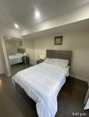 a bedroom with a large white bed and a mirror at Modern Luxury 3 bed rooms House in Toronto Mississauga in Mississauga