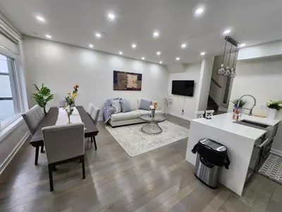 a living room with a couch and a table at Modern Luxury 3 bed rooms House in Toronto Mississauga in Mississauga