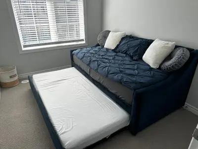 a bed in a room next to a window at Cozy Whitby Retreat in Whitby