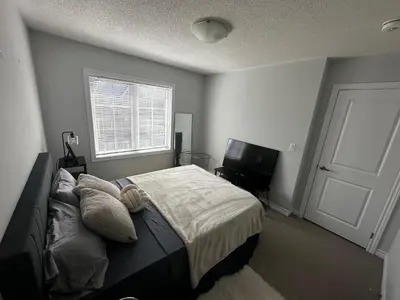 a bedroom with a bed and a window and a television at Cozy Whitby Retreat in Whitby