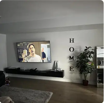 a living room with a flat screen tv on a wall at Cozy Whitby Retreat in Whitby
