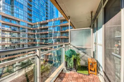 an apartment balcony with a view of a tall building at Downtown 2 bedroom Gem with Free Parking in Toronto