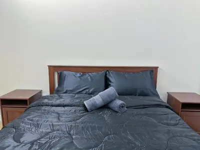 a bed with two pillows on it with two tables at Downtown 2 bedroom Gem with Free Parking in Toronto