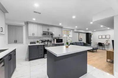 an open kitchen and living room in a house at Urban Haven: 2BR/2BA+Office, Kitchen, Dining in Newcastle