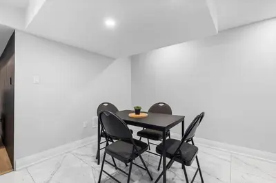 a dining room with a black table and chairs at Urban Haven: 2BR/2BA+Office, Kitchen, Dining in Newcastle