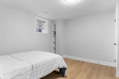 a white bedroom with a bed and a closet at Urban Haven: 2BR/2BA+Office, Kitchen, Dining in Newcastle