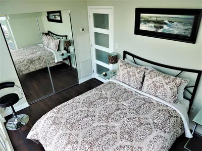 a bedroom with a bed and a mirror at TVHR - Luxury Condos in Heart of Downtown with Breakfast in Toronto