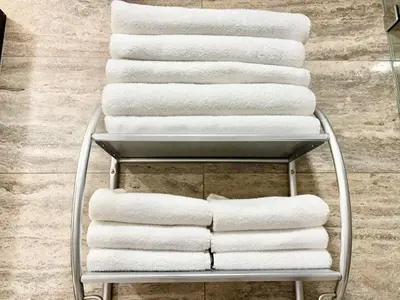 a stack of towels on a towel rack in a bathroom at TVHR - Luxury Condos in Heart of Downtown with Breakfast in Toronto