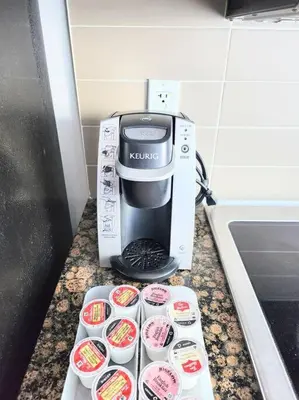 a coffee maker is sitting on a counter with cups at Luxury Suites Steps to CN Tower - Lock in 4 Weeks Enjoy Half OFF in Toronto