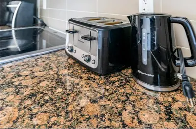 a toaster and coffee maker on a counter in a kitchen at Luxury Suites Steps to CN Tower - Lock in 4 Weeks Enjoy Half OFF in Toronto