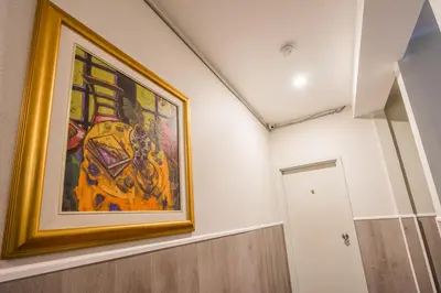 a painting hanging on a wall in a room at Pembroke suites in Toronto