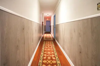 an empty hallway with a rug on the floor at Pembroke suites in Toronto