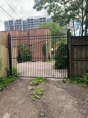 an iron gate in front of a fence at Pembroke suites in Toronto