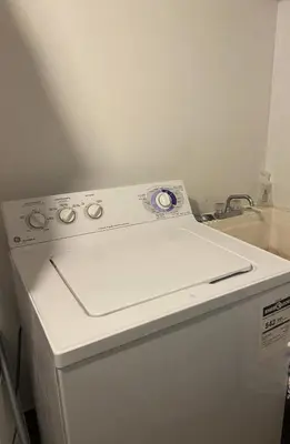 a white stove top oven sitting next to a sink at Pembroke suites in Toronto