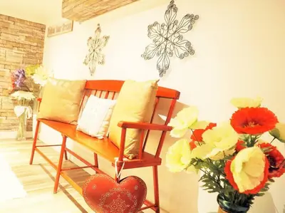 a room with a bench and a vase of flowers at LOVE and Relax at Dream Catcher Retreat in Whitby