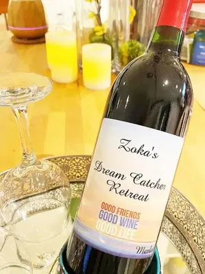 a bottle of wine sitting on a table with a glass at LOVE and Relax at Dream Catcher Retreat in Whitby