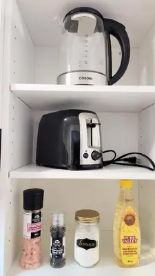 a toaster and other kitchen items in a refrigerator at The Serene Haven Modern 2 Queen Bed Full Apartment in St. Catharines