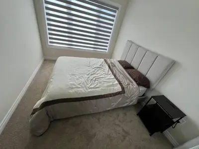 a bed in a bedroom with a window at Niagara's entertainment house in Thorold