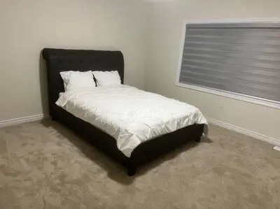 a bed sitting in a room with a window at Niagara's entertainment house in Thorold