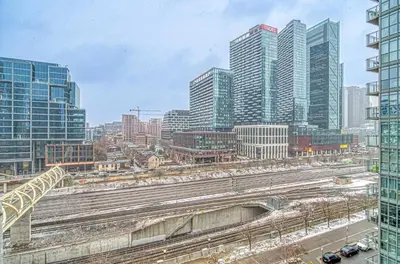 a view of a city with train tracks and buildings at The Snug 1plus1 Suite with Free Parking in Toronto