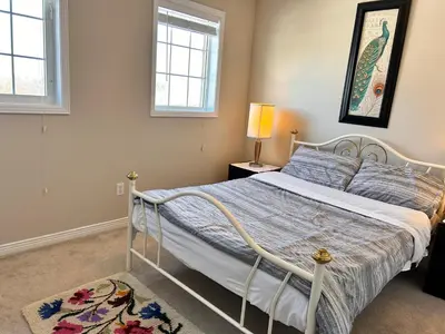 a bedroom with a bed and two windows at \u591a\u4f26\u591a\u6e56\u7554\u522b\u5885\u53cc\u4eba\u95f43 in Bowmanville